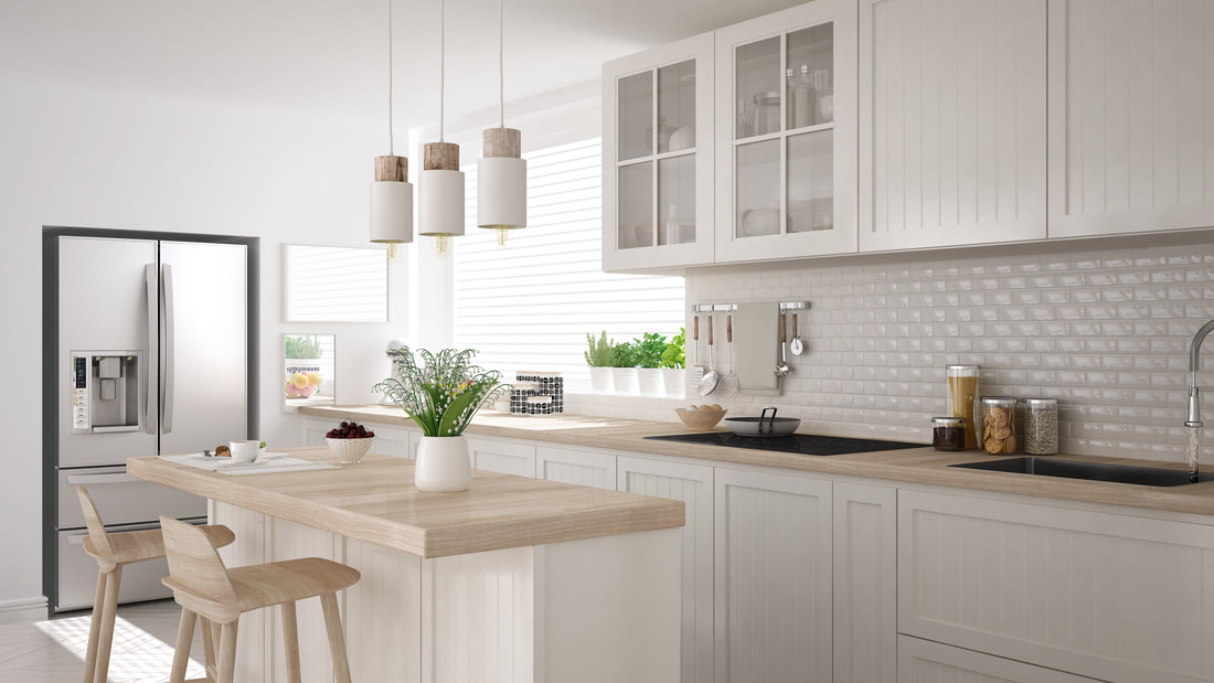 Light kitchen with a timber bench top and a subway tile splashback